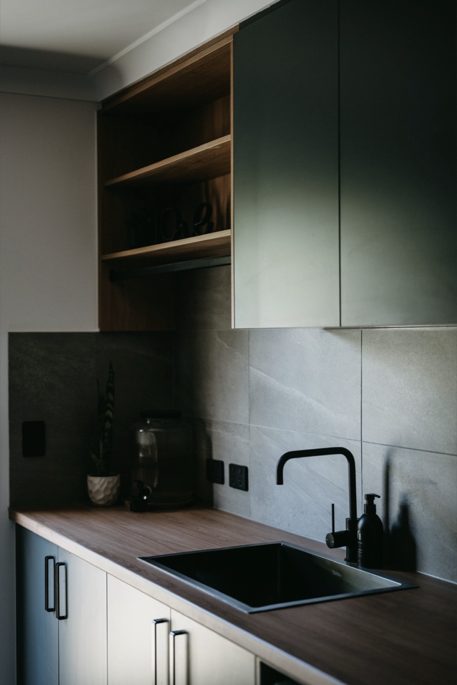 Kitchen joinery in green and timber.