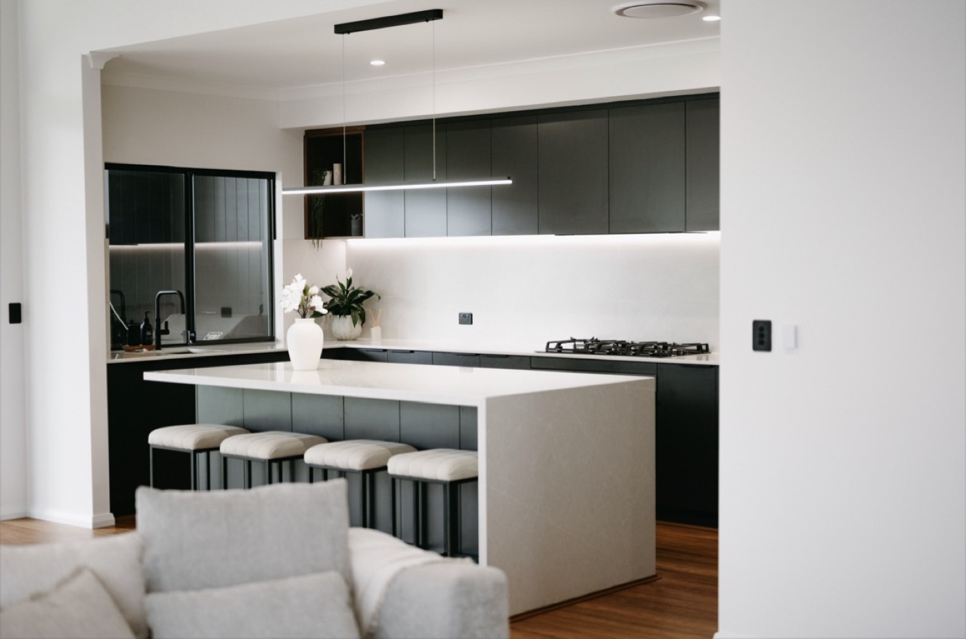 Open-plan kitchen and living with a stone island.